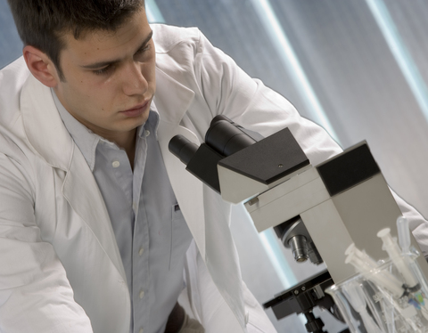researcher working on microscope